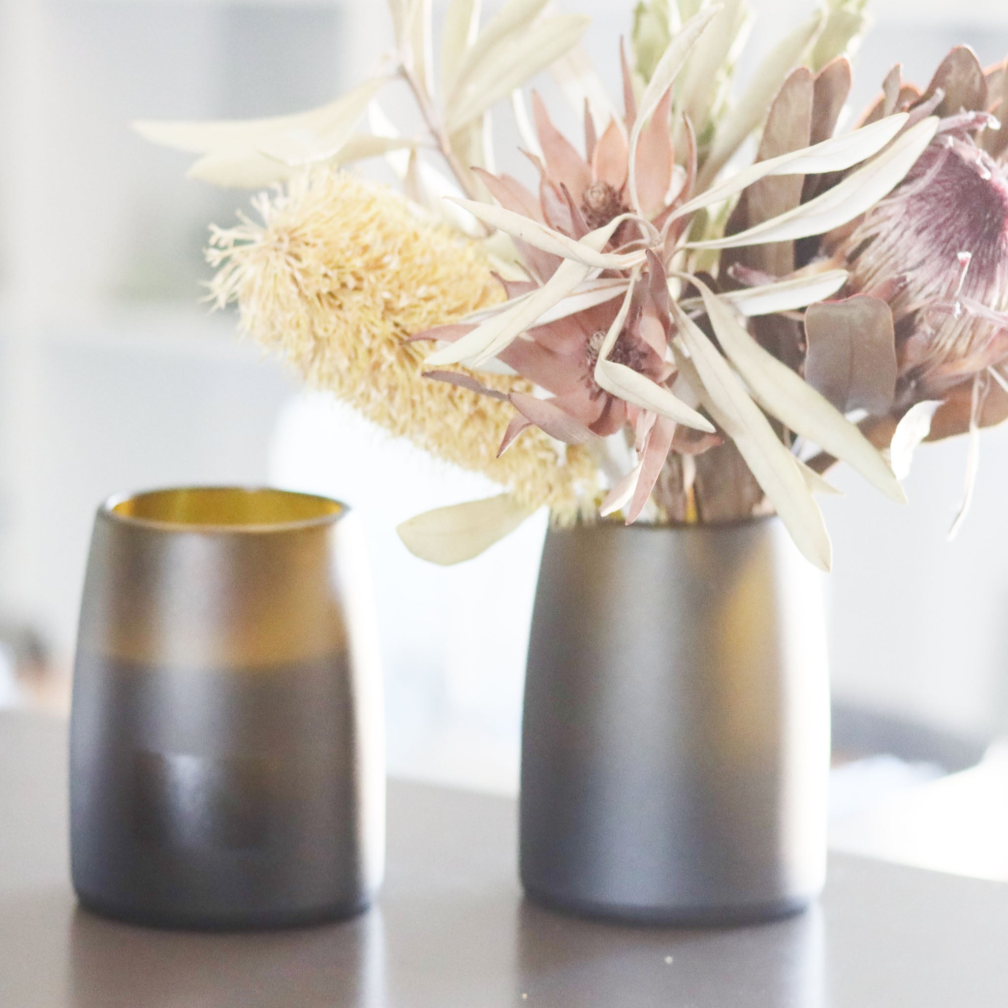 Revalued Glass Prestige Candle Vase from champagne bottles by Flickr by TBT, emitting a cozy Australian Wildflower scent, highlighting sustainable luxury and versatility in home decor