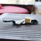 •	Image of the complete Prestige Bottle Platter on a dining table: "Exclusively designed Prestige Bottle Platter crafted from reclaimed champagne bottles, serving as the centrepiece on a modern dining setup