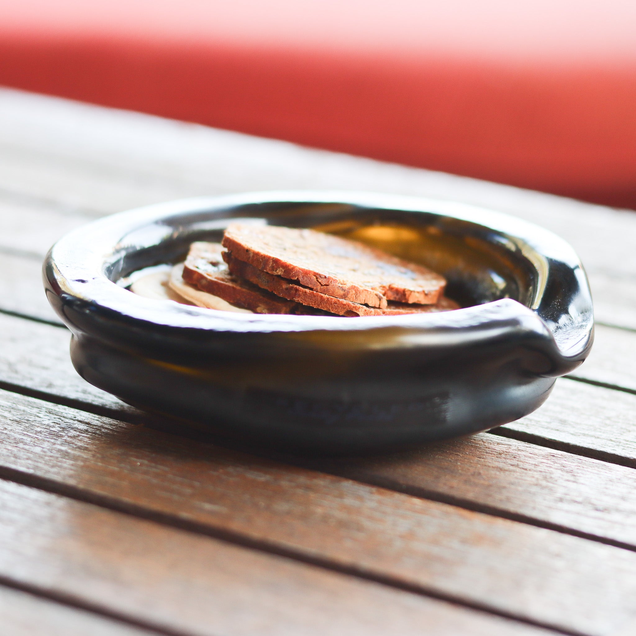 : Detailed view of the Prestige Organic Punt Dish, emphasizing its finely ground edges and captivating organic shape and  suitability for serving ware..