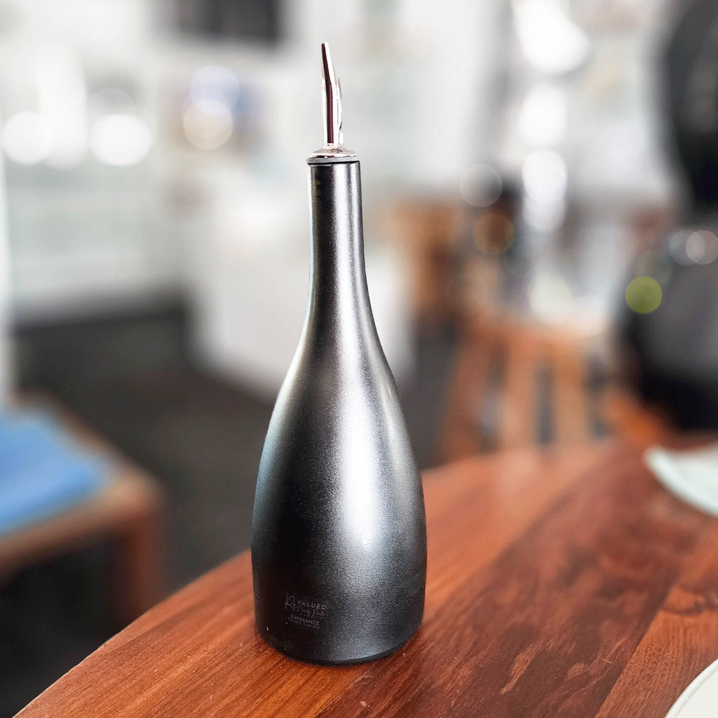 •	Image of the Prestige Glass Oil Pourer on a kitchen counter: "Luxurious and eco-conscious Large Prestige Glass Oil Pourer with unique sateen finish on display