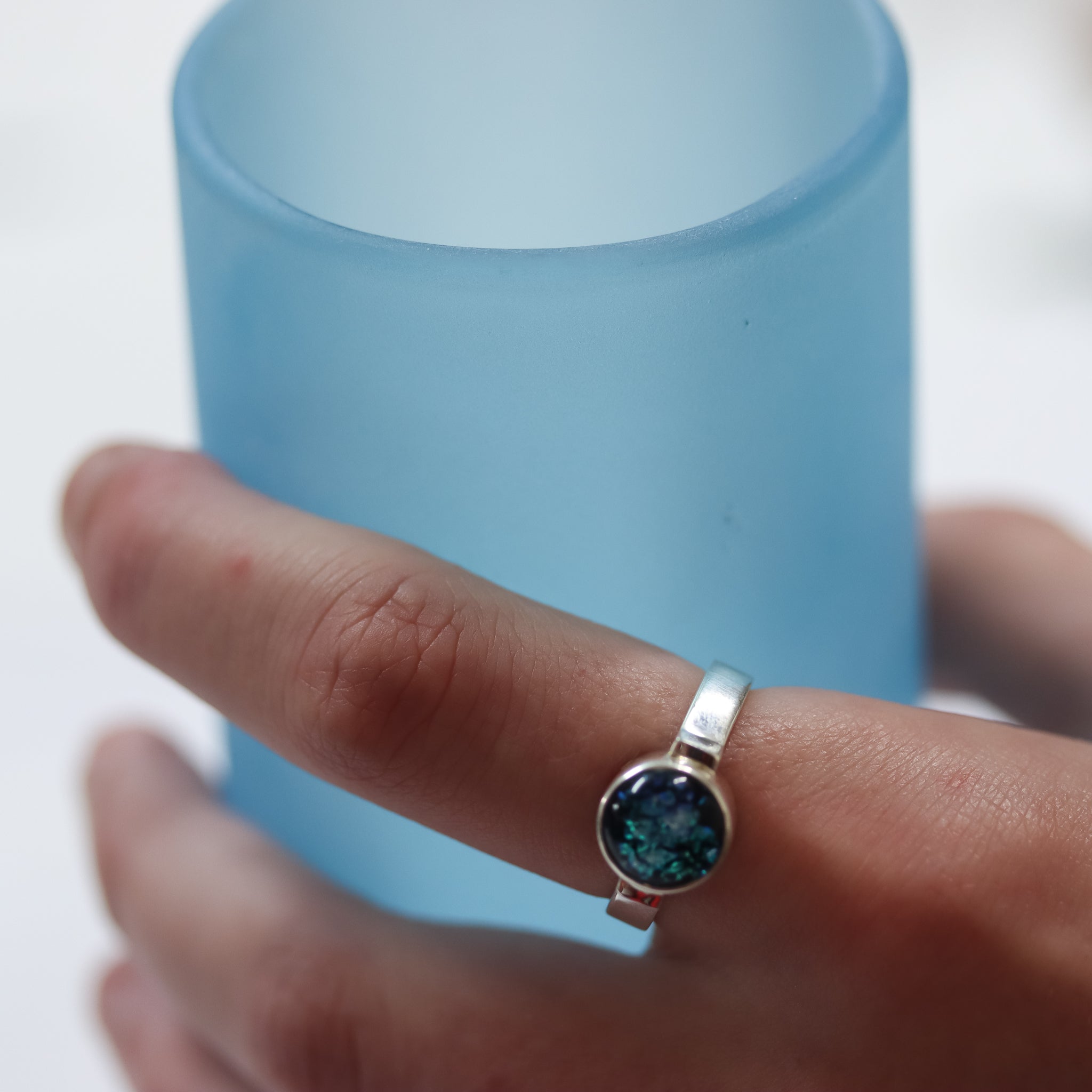 Ivy Ring being worn holding a glass.