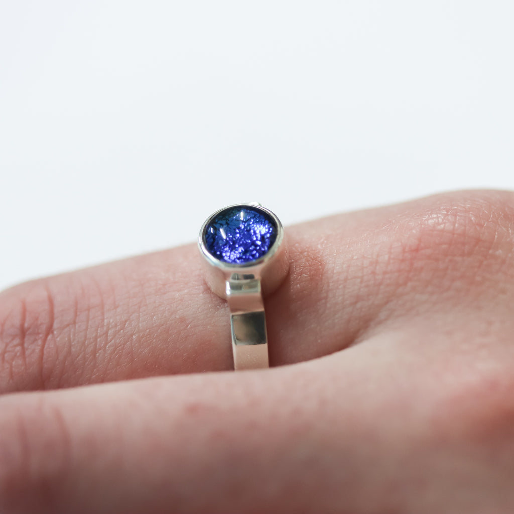 The Ivy Ring being worn in the colour of Hellfire bay highlighting the allure of dichroic art glass fused gem.