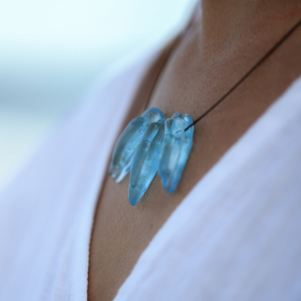 Close-up of ReValued Seaspray Sapphire glass pendant showcasing the fine sandy inclusions, evoking the Australian shore.